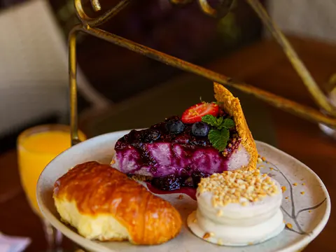 Suporte de três andares com croissant, torta e sanduíche